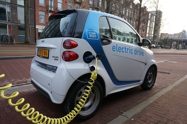 An electric vehicle plugged into a charging station.